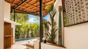 A modern interior with a pool, tropical plants, and a wooden ceiling. - Serene 1BR Villa 800 to Echo Beach, With Pool (Canggu)