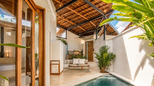 An indoor swimming pool with a wooden ceiling, a sofa, and potted plants. - Sumptuous 1-br Villa Near Canggu Beach, 800m Away (Canggu)