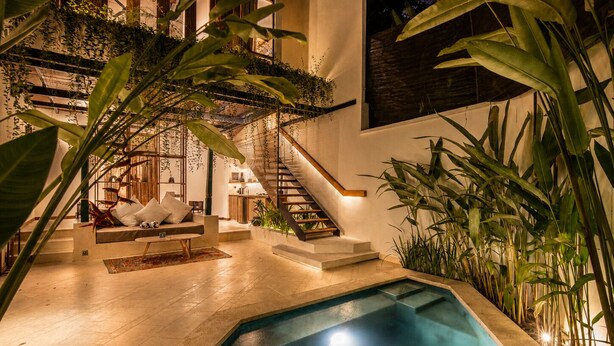 A modern interior with a swimming pool, staircase, and indoor plants. - Luxurious 1-br Villa With Pool, Echo Beach 800m (Canggu)