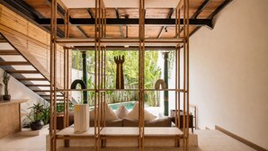 A room with a wooden partition, a staircase, and a view of a pool. - Luxurious 1-br Villa With Pool, Echo Beach 800m (Canggu)