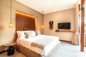 A modern bedroom with a large bed, bedside tables, a TV, and a window with curtains. - Luxury 6BR Canggu 400m to Finns Beach (Canggu)