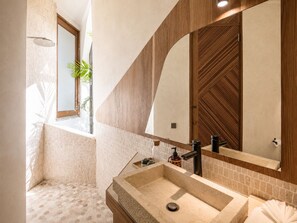 A bathroom with a large mirror, a sink, a shower, and a window with a plant. - Modern 1-br Loft With Art Deco Vibe Shared Pool (Canggu)