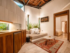 A modern kitchen with wooden cabinets, a built-in sink, and a large window overlooking greenery. - Chic 1-br Villa With Pool, 4 Mins to Echo Beach (Canggu)