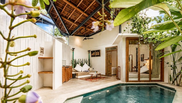 A pool area with a lounge chair, a wooden ceiling, and a door leading to another room. - Chic 1-br Villa With Pool, 4 Mins to Echo Beach (Canggu)