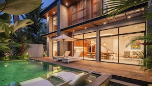 A modern house with a swimming pool, lounge chairs, and a dining area. - Contemporary 5BR Luxury Villa Just 400m to the Sea (Seminyak)