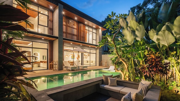 A modern house with a swimming pool, outdoor seating, and lush vegetation. - Contemporary 5BR Luxury Villa Just 400m to the Sea (Seminyak)
