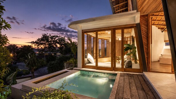 A modern house with a swimming pool, wooden deck, and glass doors leading to a living area. - Stunning 2-br Penthouse With View 800m to Beach (Canggu)