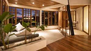 A spacious room with large windows, a wooden ceiling, and a view of the sunset. - Stunning 2-br Penthouse With View 800m to Beach (Canggu)