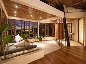 A spacious room with large windows, a wooden ceiling, and a view of the sunset. - Stunning 2-br Penthouse With View 800m to Beach (Canggu)