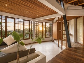 A spacious room with large windows, a wooden ceiling, and a modern design. - Stunning 2-br Penthouse With View 800m to Beach (Canggu)