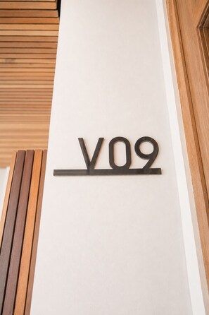 A wall-mounted sign with the letters 'V09' on a white wall. - Luxurious 1-br Villa With Pool, 800m to Echo Beach (Canggu)