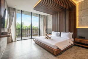 A modern bedroom with a large bed, a wooden headboard, and a view of greenery through large windows. - Modern 4BR Canggu Retreat Just 8mins to the Beach (Kerobokan)