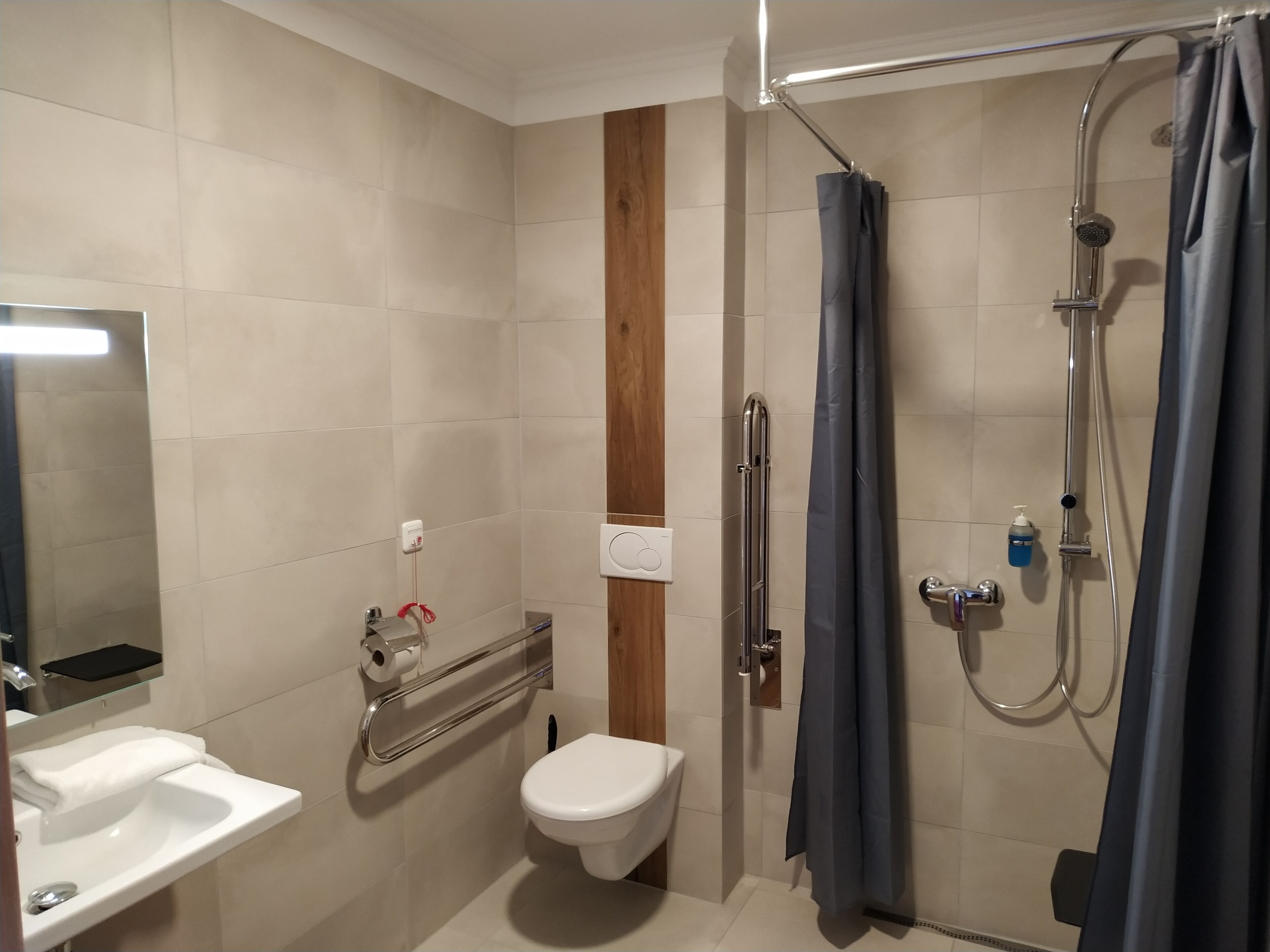 A bathroom with a sink, toilet, and shower.