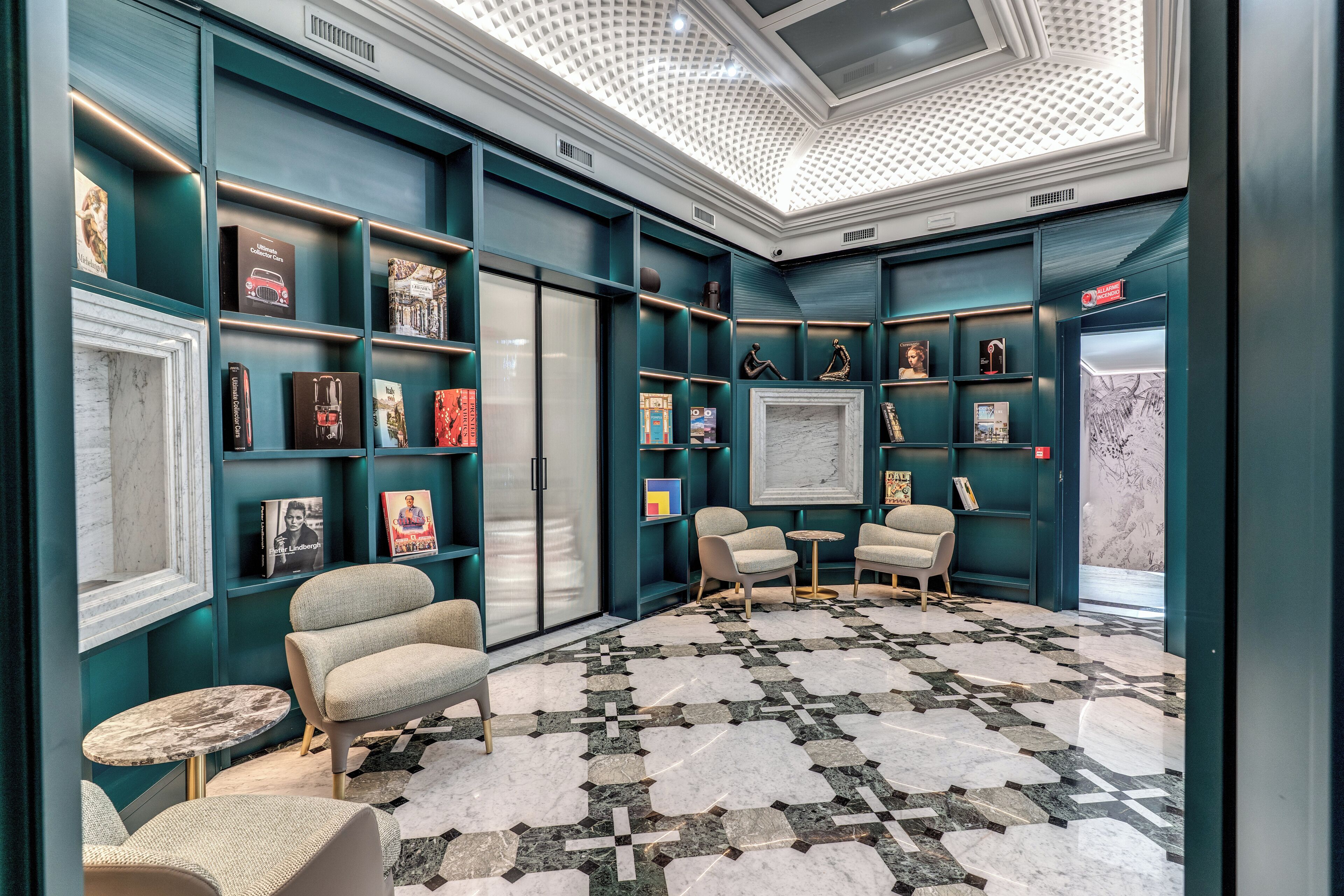 A modern interior with teal walls, a patterned floor, and a skylight.