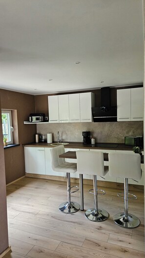 Fridge, stovetop, dishwasher, coffee/tea maker