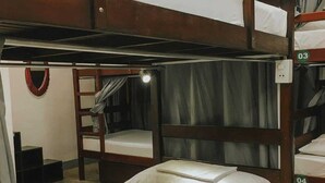 A bunk bed room with a ladder, a curtain, and a light fixture. - Teofel Hostel by Hiverooms (Cebu City)
