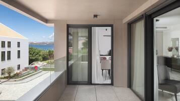 A balcony with a view of a building and a body of water.