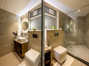 Luxury Suite, Balcony | Bathroom | Shower, slippers, towels, soap