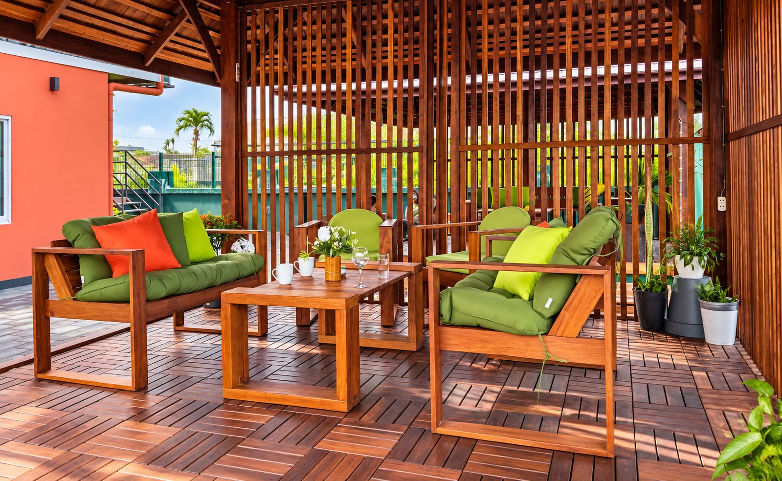 A wooden outdoor seating area with a table and chairs, surrounded by a wooden fence.