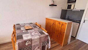 A compact kitchen with a dining area.