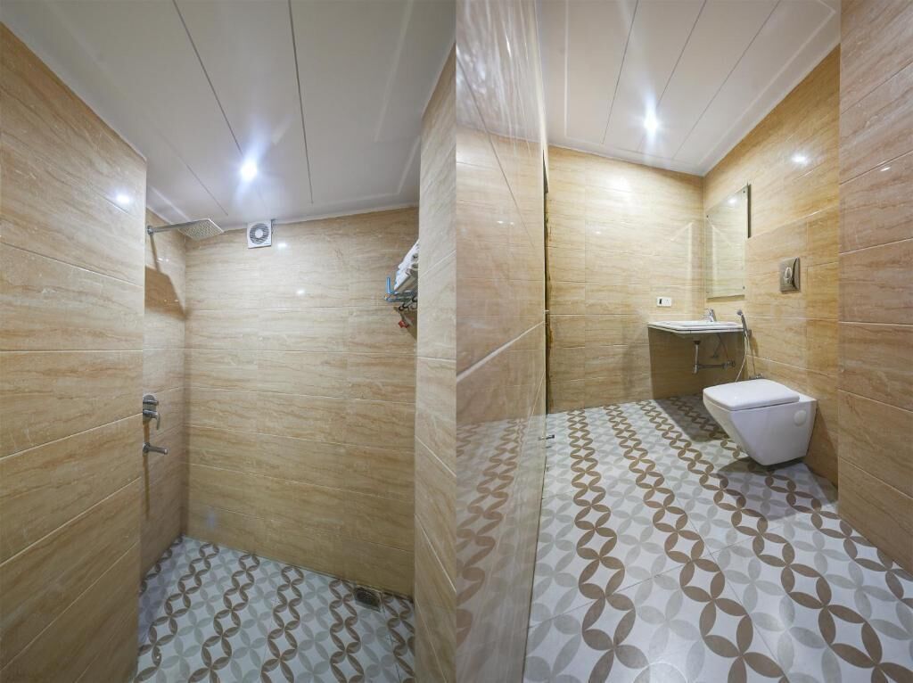 A bathroom with a shower, toilet, and sink.