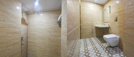 A bathroom with a shower, toilet, and sink.