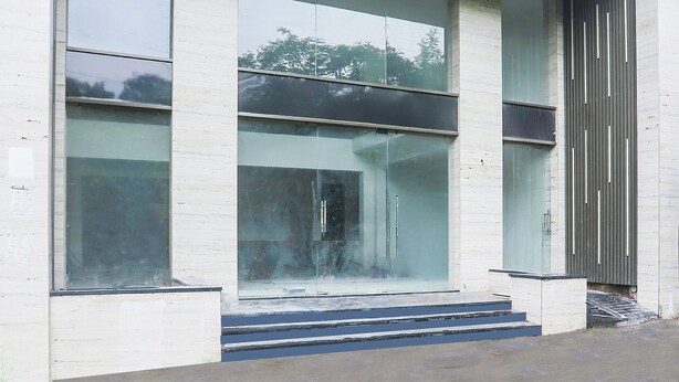 A modern building with large glass windows and a concrete facade. - Fabhotel Empire (Indore)