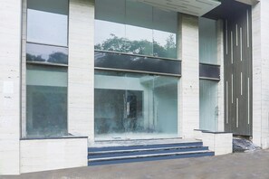 A modern building with large glass windows and a concrete facade. - Fabhotel Empire (Indore)