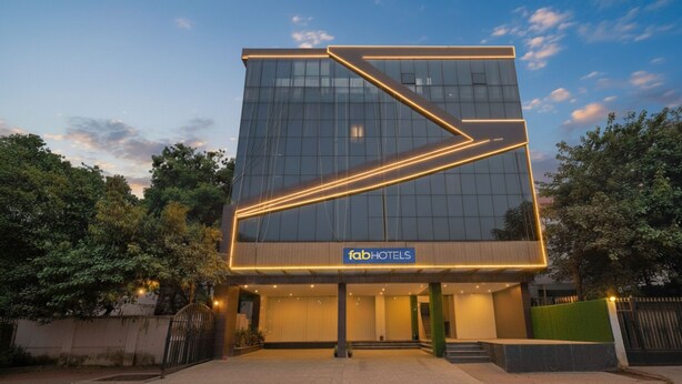 A modern hotel building with a glass facade and a prominent 'fabHOTELS' sign. - Fabhotel Western Inn (Chennai)