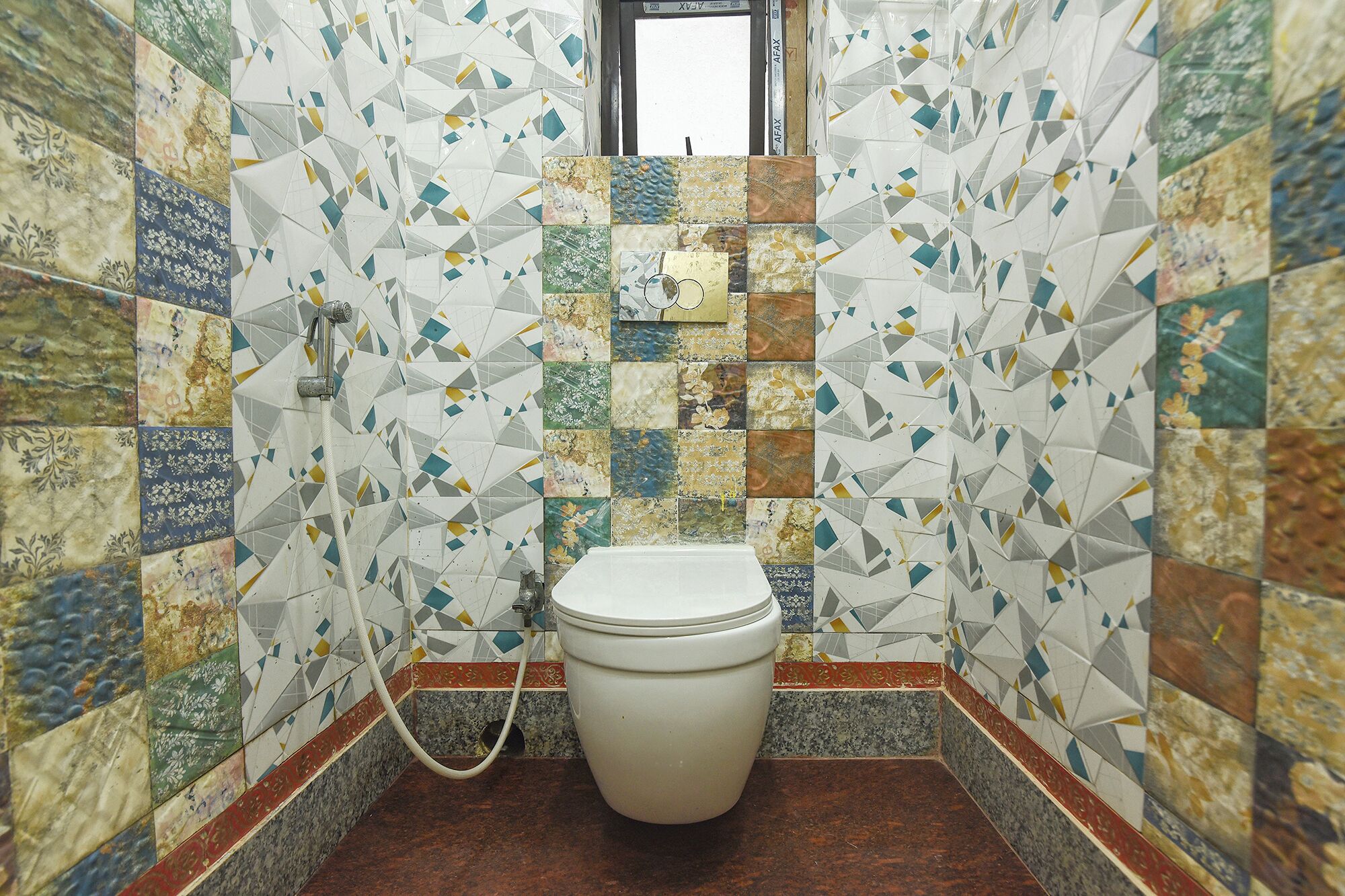 A bathroom with a toilet, a shower, and a sink.