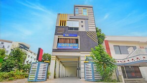 A modern hotel with a prominent sign for 'Fab Hotels' and 'Grand Hotel'. - Fabhotel Wild Wings Ecil (Hyderabad)