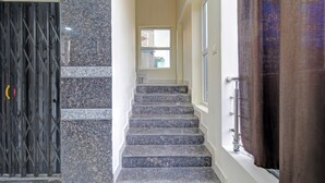 A staircase with granite steps leading to a landing with a window. - Fabhotel Wild Wings Ecil (Hyderabad)