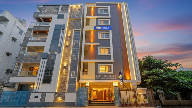 A modern multi-story hotel with a prominent facade, balconies, and a well-lit entrance. - Fabhotel Rio Hitech City (Hyderabad)