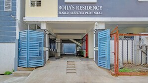 A residential building entrance with a staircase leading to the upper floor. - Fabhotel Rio Hitech City (Hyderabad)