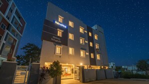 A modern hotel with a sign reading "Tab Hotels" and "Shubram Nallagandla". - Fabhotel Smart (Hyderabad)