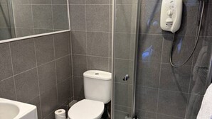 A modern bathroom with a glass-enclosed shower, a toilet, and a sink. - Cairn - one bedroom apartment sleeps up to three (Midlothian)