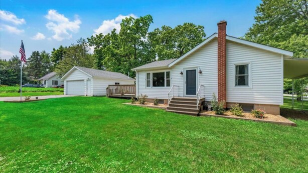 A single-story house with a front porch, a garage, and a brick chimney. - Steps to the Lake- Cozy 2 Bedroom Retreat (Bristol)