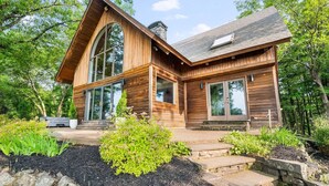 A modern log cabin with large windows, a stone foundation, and a well-maintained garden. - Catskill Estate w Epic Views hot tub (Kingston)