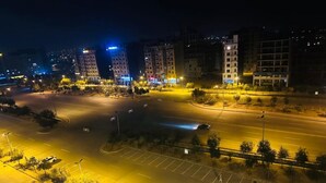 A nighttime view of a parking lot with several cars and a few trees. - Skyline apartments, escape to the skys. Clean and peaceful (Rawalpindi)