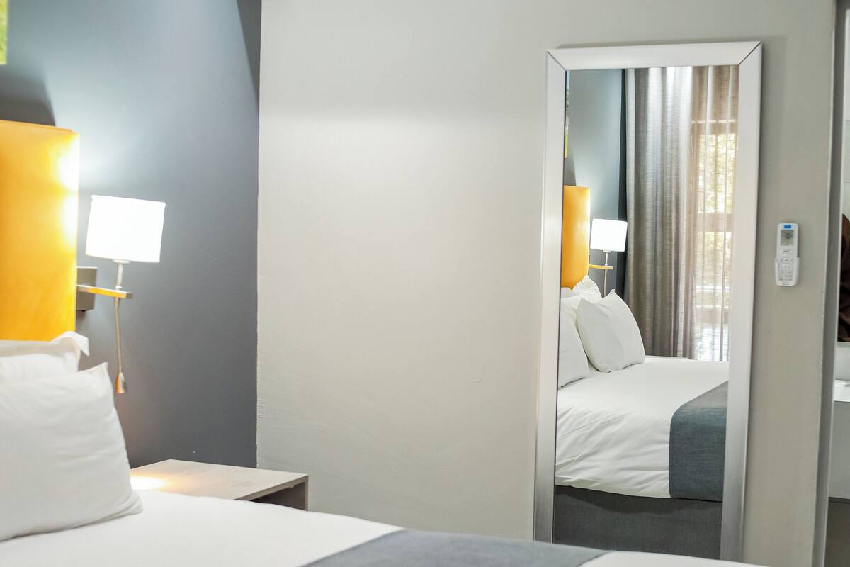 Deluxe Room, Pool View | Minibar, in-room safe, desk, laptop workspace