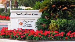 A sign for Santa Rosa Cove with the Mountain Dunes Golf Courses logo. - SRC81 - 3 BD / 2 BA, 1591 sf - Remodeled Chapala! (La Quinta)