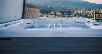 Spacious 4-bedroom home, AC, beautiful backyard with views, and deluxe hot tub.