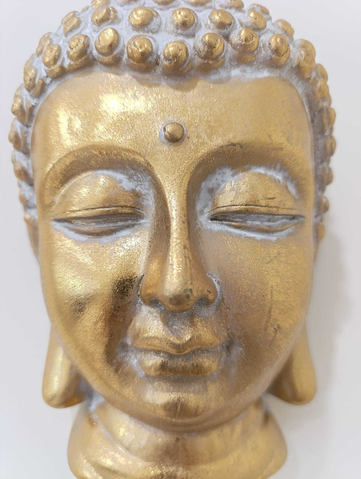 A golden Buddha head sculpture.