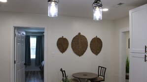 A dining area with a table, chairs, and a vase of flowers. - Delightful 2-bedroom house with AC in charming Easley (Easley)