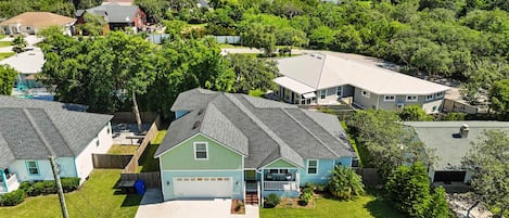 A residential area with houses featuring sloped roofs and front yards.