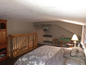 A bedroom with a bed, a desk, a chair, and a lamp. - Private River in the back yard (Wilkesport)