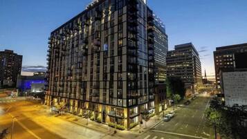 A multi-story hotel with a modern design, featuring a large glass facade and multiple balconies.