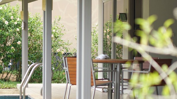 A covered outdoor area with a pool, seating, and a table. - 2 Bedroom Neer Phuket Airport (Sa Khu)