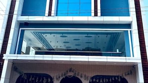 A multi-story building with a prominent ISIRI sign at the top. - Golden Crown Suites (Anekal)