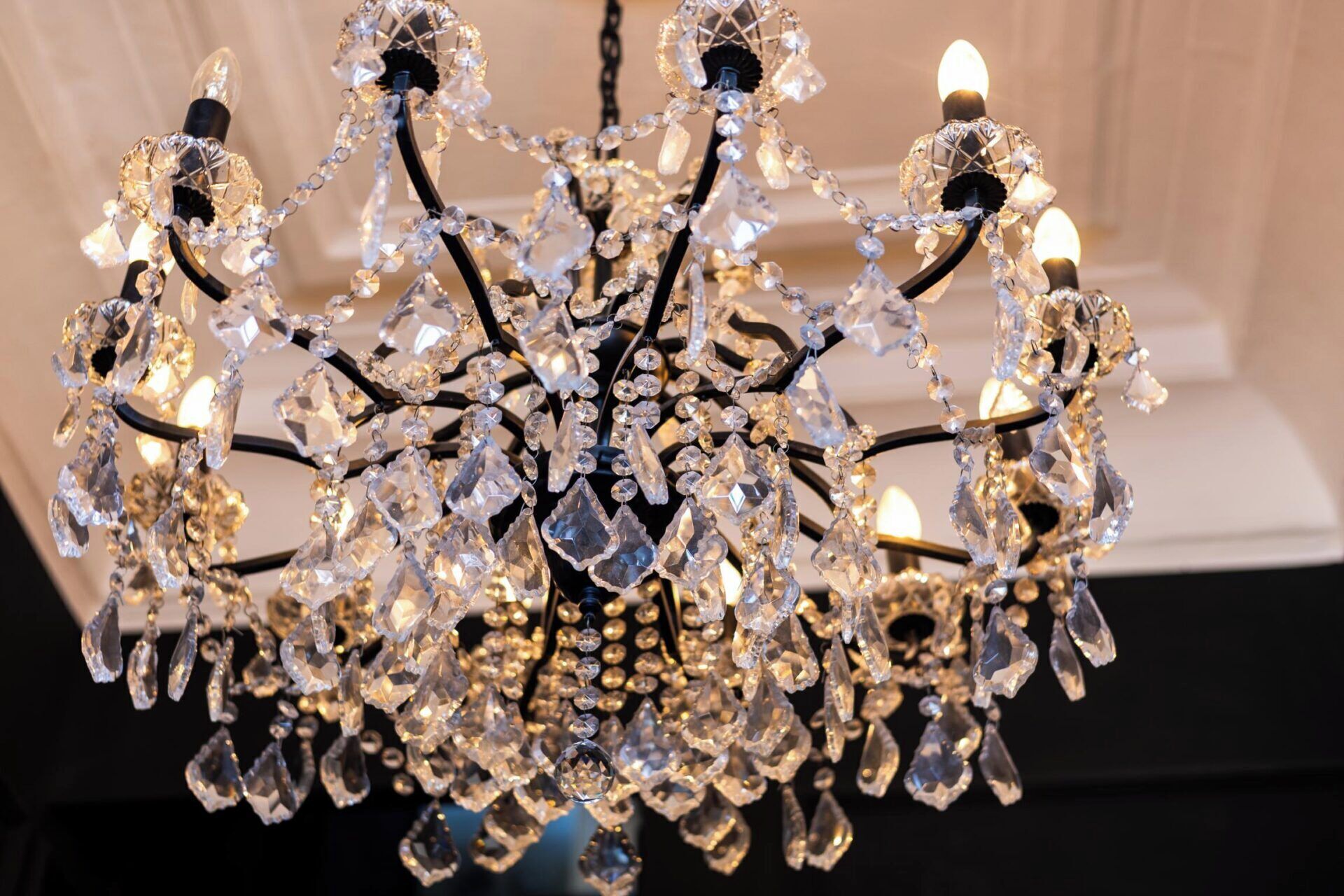 A chandelier with multiple arms and crystal decorations.